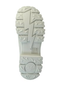 White rubber shoe sole featuring a lightning bolt design, textured surface with triangular patterns, and a circular brand logo at the heel.