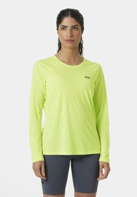 Langdurige sportshirt met lange mouwen in fluorescent geel, voorzien van een ronde halslijn en een gladde, lichte stof. Subtiel merklogo op de borst.