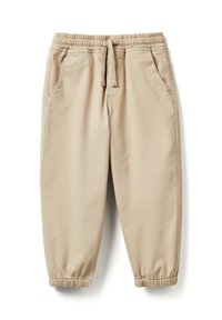 Beżowe bawełniane spodnie dresowe z elastycznym pasem, sznurkiem do wiązania, bocznymi kieszeniami oraz elastycznymi ściągaczami przy kostkach.