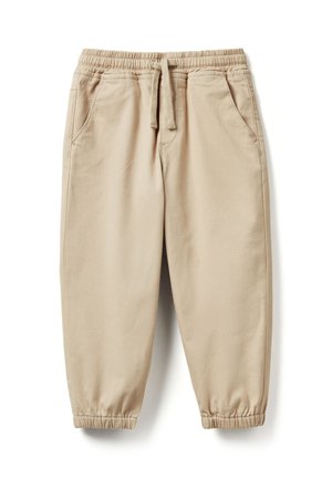 Béžové bavlněné teplákové kalhoty s elastickým pasem, stahovací šňůrkou, bočními kapsami a elastickými manžetami u kotníků.