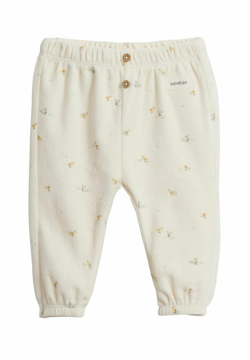 Krämfärgade babbyxor i mjuk fleece, med ett blommönster och elastisk midja med träknappar. Märkesetikett synlig.