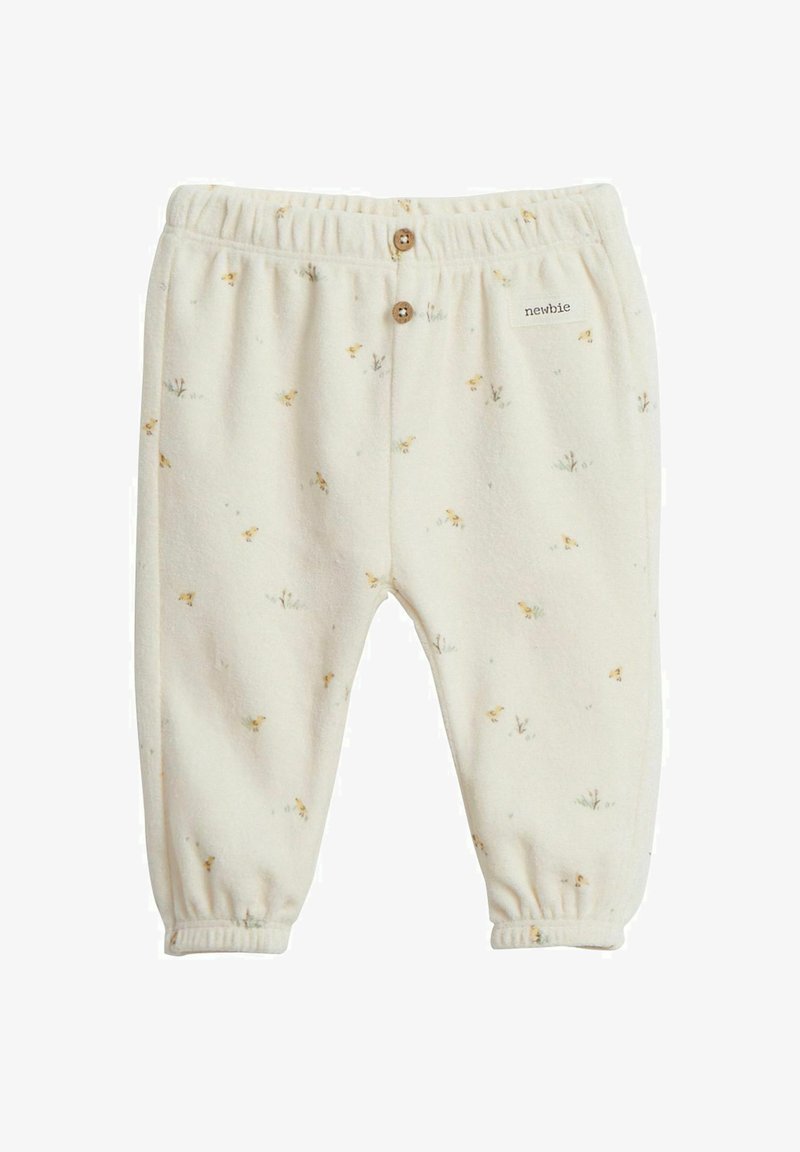 Cremfarbene Babypants aus weichem Fleece, mit floralem Muster und elastischem Bund mit Holzknöpfen. Markenlabel sichtbar.