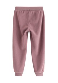Fleece-Jogginghosen in staubigem Rosa, mit einem gerippten Bund und elastischen Bündchen. Glatte Textur mit einem leicht zulaufenden Beinin.