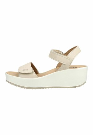 Beige dames kile-sandal med to justerbare velcrobånd og en tyk hvid plateau sål.