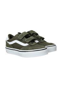Zapatillas de lona verdes con acentos laterales blancos, que cuentan con dos tiras de Velcro. Suela de goma con detalles de rayas negras y punta texturizada.
