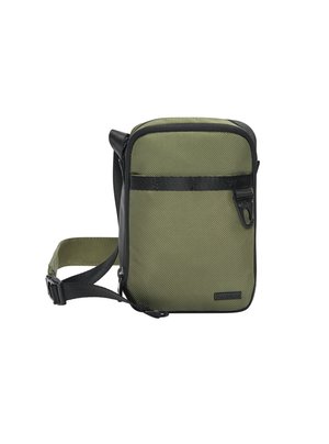 Olive green crossbody bag with textured fabric, black accents, adjustable strap, and front zip pocket. Compact rectangular design.