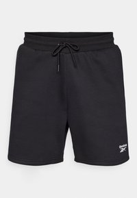 Čierne športové šortky s elastickým pásom a šnúrkou. Obsahujú biele logo Reebok na dolnej pravej nohe. Mäkko, textúrované tkanivo.