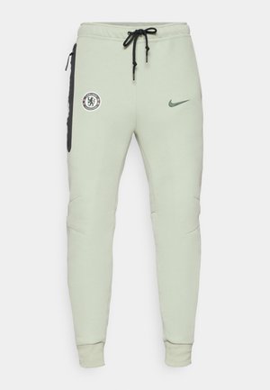 Lys grønne treningbukser med en tettsittende design, med Chelsea FC-logo og Nike swoosh, sidelommer med svarte detaljer, og elastiske mansjetter.