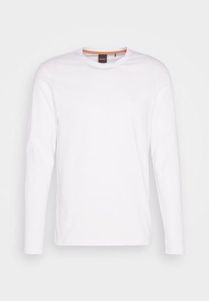 Biała koszulka z długim rękawem wykonana z bawełny. Posiada okrągły dekolt oraz małe wytłoczone logo na lewej piersi. Gładka struktura.