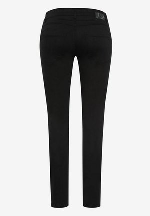 Black skinny jeans made of denim, featuring a mid-rise waist, two back pockets, and a subtle design element on the right rear waistband.