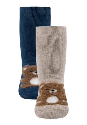 Two pairs of children's socks, one navy blue, one beige, each with a fuzzy bear face design near the toes.