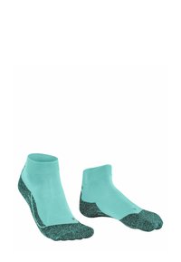 Para turkusowych skarpetek kostkowych z teksturowanym czarnym gripem na podeszwie, zaprojektowanych dla komfortu i stabilności podczas aktywności.