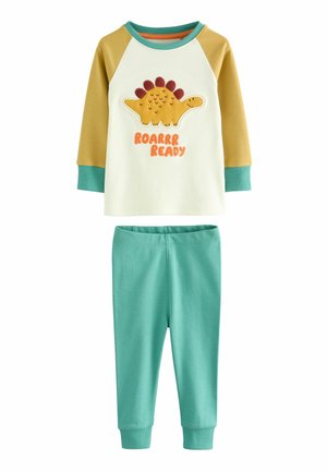 Conjunto de pijama de algodón con una camiseta de manga larga color crema que presenta un gráfico de dinosaurio y texto en naranja. Acompañado de leggins en color teal con puños ajustados.