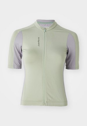Maillot de cyclisme à manches courtes en vert clair avec des accents violets. Il dispose d'une fermeture éclair à l'avant, d'un col rond et d'un tissu texturé.