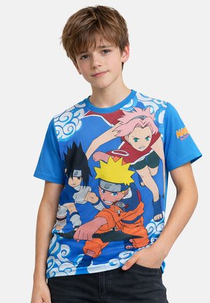 Boy wearing blue T-shirt featuring Naruto anime characters in dynamic poses with ninja headbands, holding a weapon and surrounded by clouds.