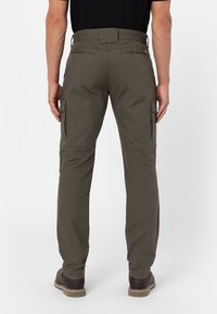Olive green cargo pants with a straight cut, featuring side pockets, stitched accents, and a durable fabric texture.