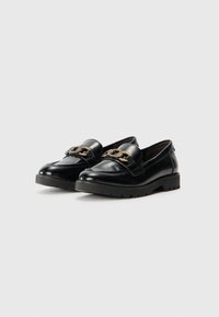 Black patent leather loafers with a chunky black sole and a decorative gold chain accent across the vamp. Smooth texture and rounded toe design.