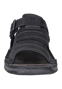 Svarta sandaler med läderremmar med vit söm, justerbar spänne, öppen tådesign och texturerad gummisula.