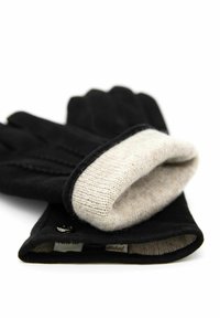 Black gloves with a soft beige knit cuff, featuring stitching details and a small logo tag. The material appears smooth and textured.