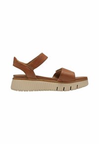 Sandalia de cuero marrón con suela gruesa beige con acanaladuras, correa ajustable en el tobillo y diseño de punta abierta.