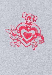 Grått tyg med tre tecknade figurer i stark rosa, med en stor hjärtformad design, som visar en texturerad, distressed effekt.