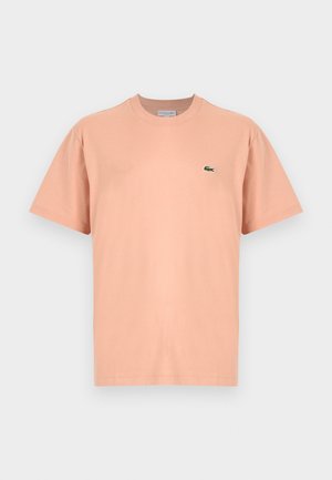 Kurzarm-T-Shirt mit Rundhalsausschnitt aus leichtem Pfirsichbaumwolle, mit kleinem grünen Lacoste-Krokodil-Logo auf der linken Brust.