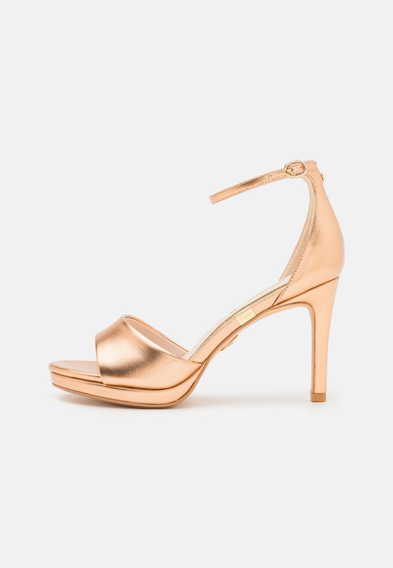Ροζ χρυσές ψηλοτάκουνες σάνταλες με μεταλλική επένδυση, ανοιχτή μύτη, φαρδιά λωρίδα μπροστά, λωρίδα αστραγάλου με χρυσό κούμπωμα και πλατφόρμα.