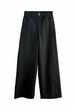 Svarta vidbenade jeans i denim, med hög midja, framfickor och kontrasterande sid söm. Rent, minimalistiskt design.
