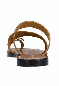Brown leather sandals with two curved straps. The sole is black with white stitching. The design is flat and open, suitable for warm weather.