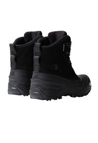 Black waterproof ankle boots with a textured suede upper, metal eyelets, and a rugged rubber sole designed for traction and stability.