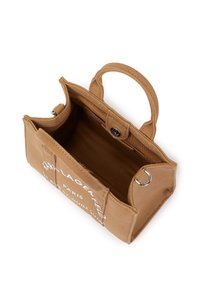 Brown canvas bag with dual handles, an open top, and printed white text on one side. Interior features a soft lining and a side pocket.