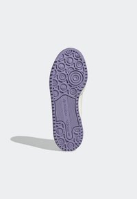 Purple rubber shoe sole featuring circular patterns and textured grip. "adidas" logo embossed on the side. Smooth transition to the shoe upper.