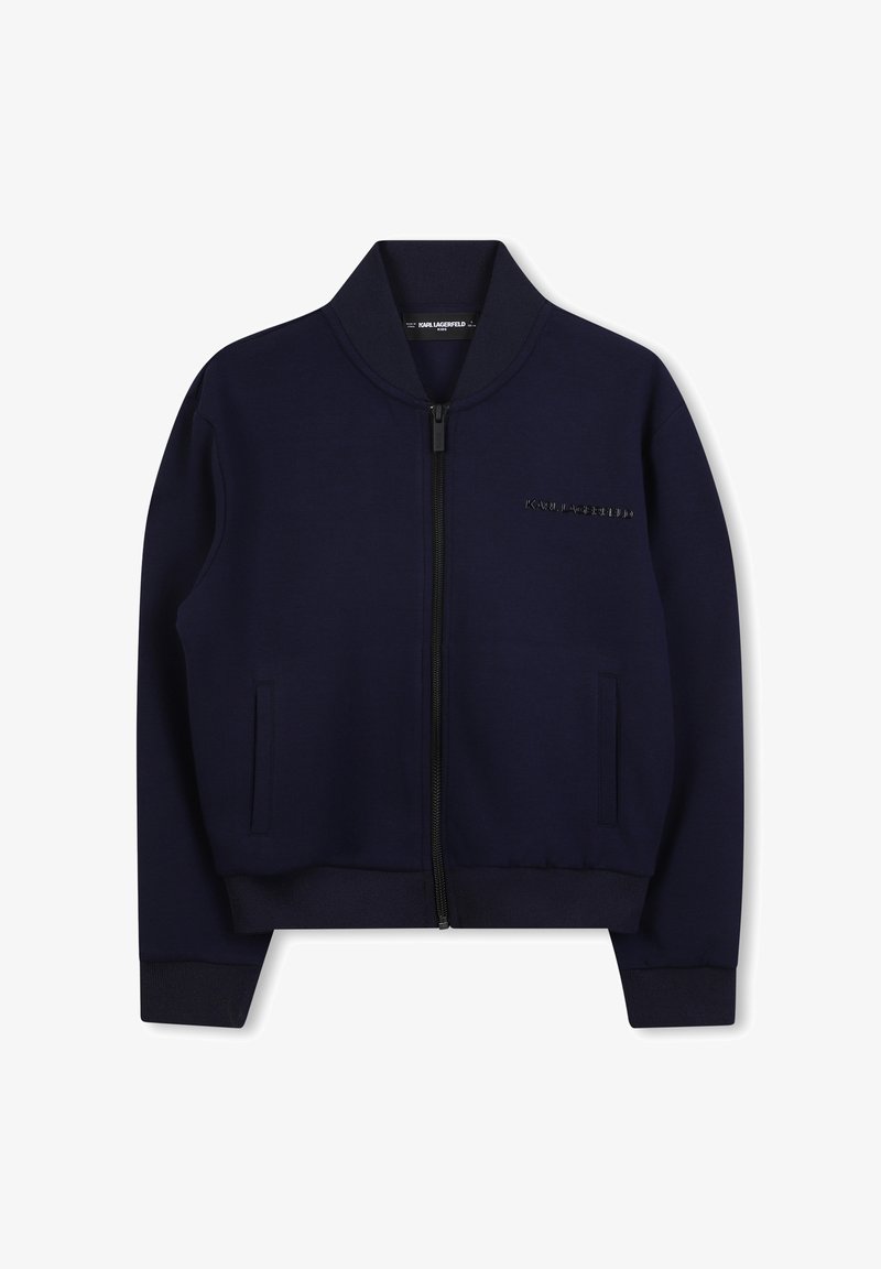 Veste zippée bleu marine avec col, poignets et ourlet côtelés, dotée de poches latérales et du logo "KARL LAGERFELD" sur la poitrine.