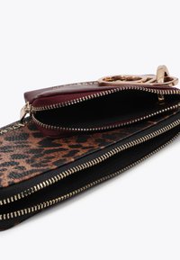 Leather wallet with a burgundy exterior and leopard-print fabric; features gold-tone zipper hardware and multiple compartments.