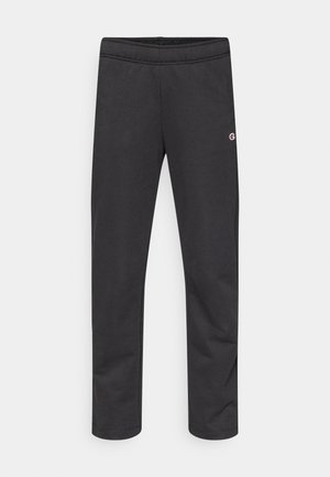 Black cotton jogger pants with an elastic waistband and a small logo on the side. Smooth texture, tapered design, no additional patterns.