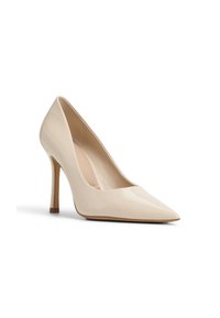 Pompe à talon haut en cuir verni beige avec un bout pointu et un talon aiguille fin. Fini lisse et brillant avec un design minimaliste.