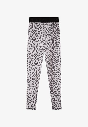 Leggings de estampado de leopardo en blanco y negro con una textura suave y cinturilla elástica que muestra "ABRIL" en verde.