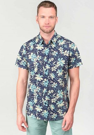 Camicetta a maniche corte in navy con un motivo floreale in tonalità blu chiaro e crema. Colletto con bottoni e vestibilità comoda.