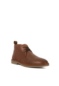 Brown leather ankle boot with a round toe, minimalistic design, lace-up front, and a textured outsole. Features a pull tab at the back.