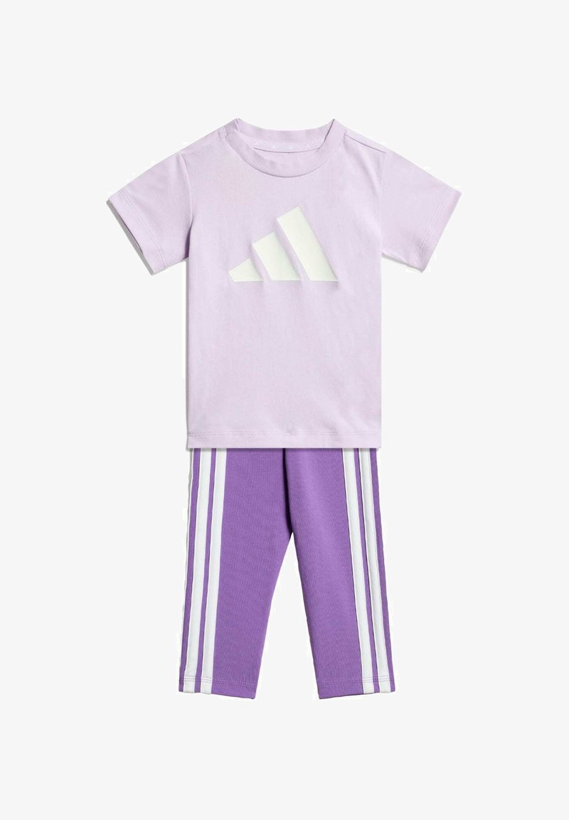 Hellviolettes Baumwoll-T-Shirt mit weißem dreieckigem Logo; passende violette Leggings mit drei weißen Streifen entlang der Seiten.