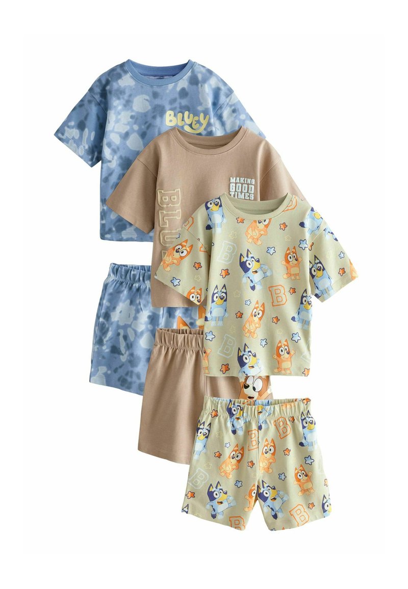 Three pairs of kids' short sets: blue and beige tones with cartoon animal prints, short sleeves, and elastic waistbands. Soft cotton material.