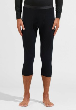 Schwarze, dehnbare Leggings mit passendem Design, bis zur Wade abgeschnitten. Mit einem glatten Bund und einer weichen Textur. Geeignet zum Schichten.