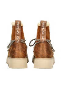 Stivali in pelle marrone con rivestimento in pelliccia color crema, suole spesse beige, lacci grigi e linguette con marchio "REPLAY" sul retro, mostrati da dietro.