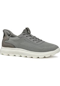Scarpa atletica grigia con tomaia in mesh testurizzato, design con lacci, morbidi dettagli grigi e suola bianca imbottita con motivo a onde.