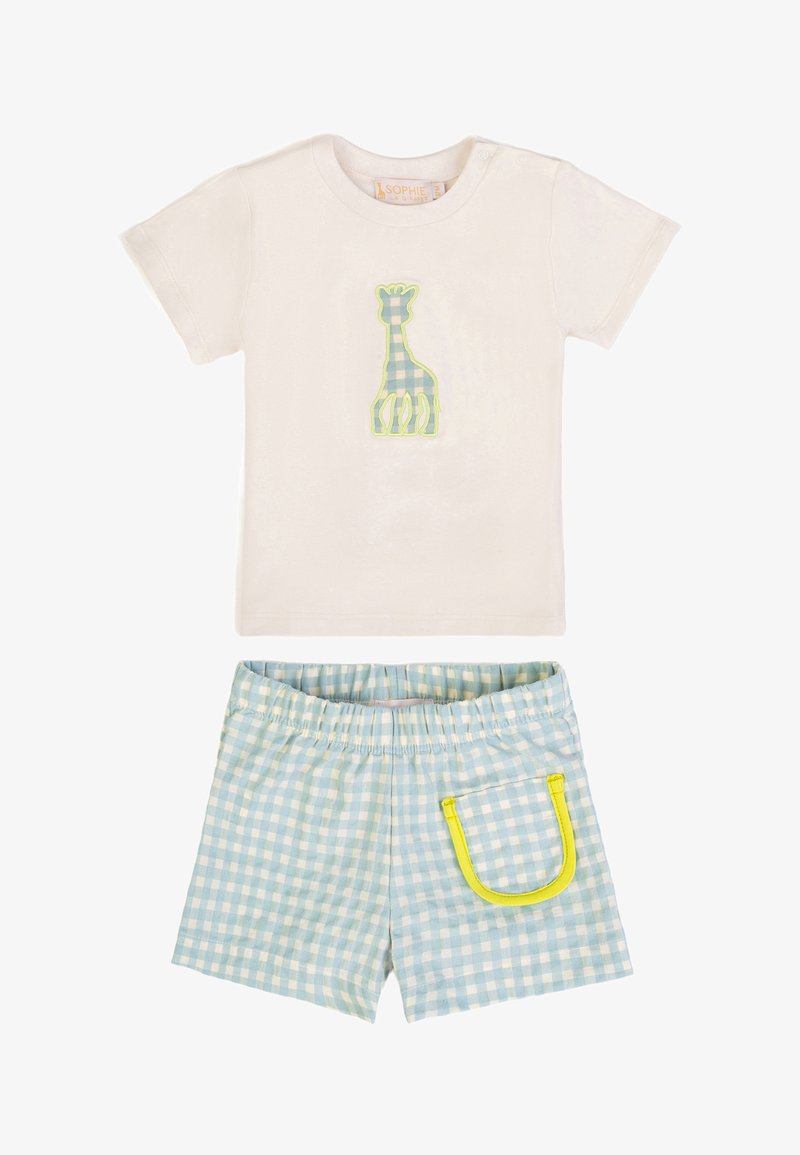 Maglietta crema a maniche corte per toddler con applicazione di giraffa blu a quadretti vichy, abbinata a pantaloncini a quadretti bianchi e blu con tasca rifinita gialla.