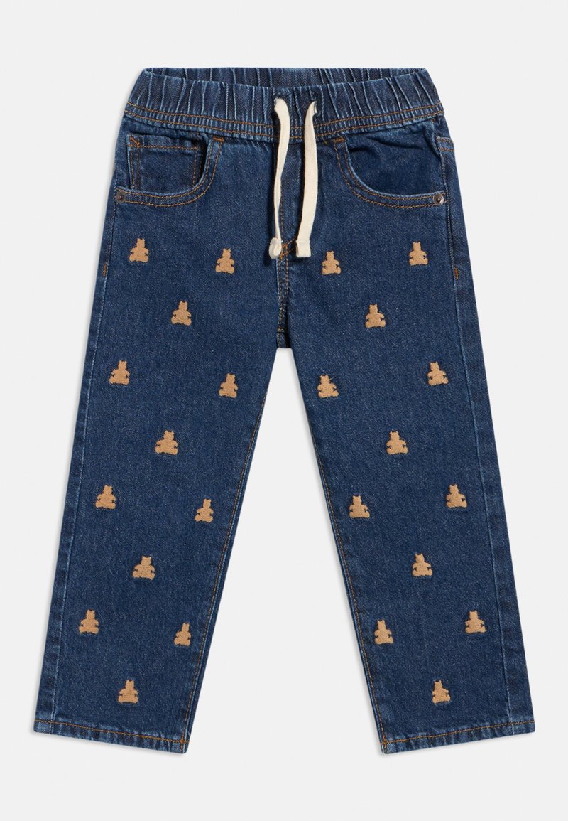 Denimpüksid elastse taljeosaga ja nööriga, millel korduv pruun karu muster, viis taskut ja sirge säärega disain.