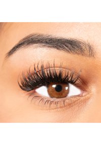 Close-up of a brown eye with long, thick, black eyelashes and a well-groomed dark eyebrow, highlighting texture and definition.