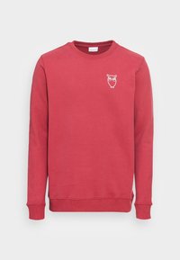 Red cotton sweatshirt with long sleeves and a crew neck, featuring a white owl graphic on the chest and ribbed cuffs and hem.