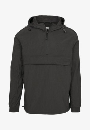 Veste pull noire en tissu léger. Dotée d'une fermeture éclair à moitié à l'avant, d'une capuche réglable et d'une grande poche avant. Manches longues.