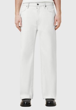 White denim jeans with a straight-leg cut, five-pocket design, visible stitching, and a button closure at the waistband. Multi-contrast hardware.